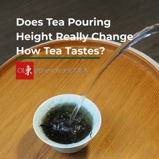 A kettle pouring hot water from a height into a tea cup on a wooden tray, illustrating an article about whether tea pouring height changes how tea tastes.