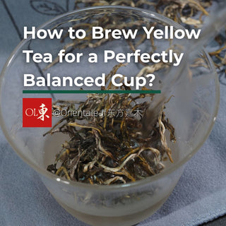 Hot water being poured over loose yellow tea leaves in a glass cup for a guide on how to brew yellow tea