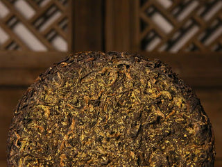 The round Fu brick tea cake is densely covered with golden fungus flowers