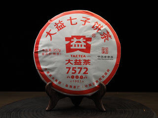 Front wrapper of 2019 Dayi '7572' Ripe Puerh Tea Cake Batch 1901, showing the iconic red and white Menghai Tea Factory package design on a display stand.