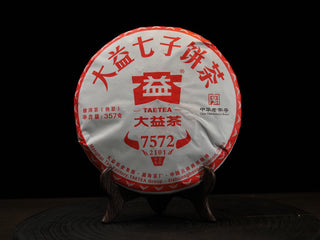 Front wrapper of 2021 Dayi '7572' Ripe Puerh Tea Cake Batch 2101, showing the classic red and white Menghai Tea Factory design.