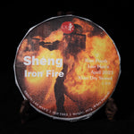 Front view of the 2023 Iron Fire Lao Man'e raw Puerh tea cake wrapped in its fiery Tiehua molten iron art wrapper on a wooden stand.