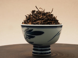 2024 Bulang Mountain bold ripe pu-erh loose leaf tea in a ceramic bowl