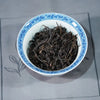 Floral Wuyi Rock Oolong Tea – Jin Guanyin (204 Cultivar) dry tea leaves displayed in a gaiwan, showing tight dark-green strips and floral aroma potential.
