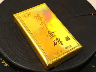 Gold Brick 2012 sun-dried Fuding White Peony 500g brick in its gold wrapper with calligraphy label and Liufeng Tea branding.