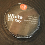 Front view of Silk Ray Fuding Bai Mu Dan white tea cake wrapped in minimalist laboratory-style paper packaging, March 2023 harvest.