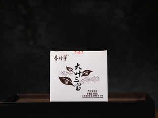 Front view of Yunnan Raw Pu-erh Waffle Cakes – Three Legendary Leaves 400g box packaging