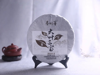Three Legendary Leaves Raw Pu-erh Tea Cake - Yunnan Sheng Puerh blend front view and traditional wrapper.
