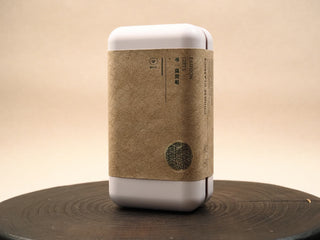 White tin box for 2014 Fuding White Peony waffle cake with kraft paper band and gold seal, FASHION GIFTS label on front.