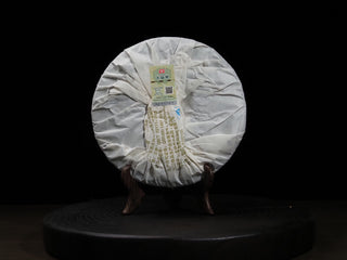 Back wrapper of 2016 Dayi 7532 Sheng Puerh tea cake, displaying the batch code 1601 and anti-counterfeiting security label.