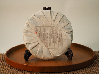 Back of the wrapped Jing Chang Hao Quiet Years 2018 raw Pu-erh cake with product details printed on the folded paper wrapper
