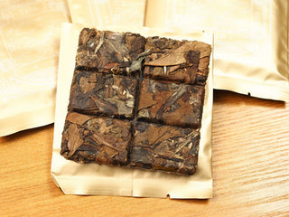 2024 Fuding Shou Mei and Chen Pi waffle cake unwrapped from gold packaging, showing the square scored cake with six break-apart sections.