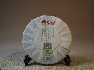 Back wrapper and official authentication label of 2026 Tan Chun Lincang raw Puerh tea cake.