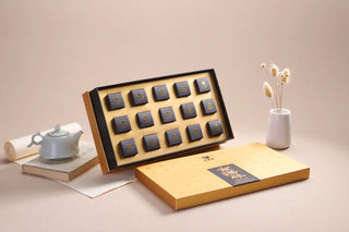 Open black gift set revealing individually packed 300-year Gushu Pu-erh dragon pearls, showcasing the high-end product design.