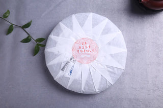 Back of the 2016 Sheng Puerh cake showing the traditional paper fold and product information label.