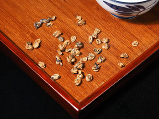 Close-up texture of curled buds in Golden Snail Dianhong tea