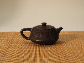 Guyun Shipiao Yixing teapot reverse side view, carved calligraphy on gritty 30-mesh antique bronze clay, bamboo mat