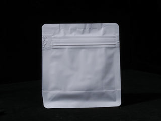 Front view of a white multi-layer aluminum foil tea pouch featuring a resealable zipper and high-barrier protection.