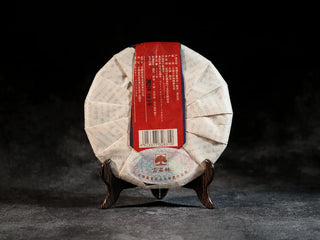 Back view of Qilin Hao Fengshan Gushu Ripe Pu-erh Tea Cake 2021 showing Ancient Tree tea seal and packaging details