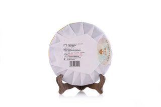 Back view of 8-year aged Pu-erh tea cake showing production and authenticity details