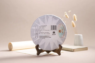 Back view of the Lincang Sheng Puerh tea cake showing product details and authenticity label.