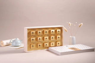 Premium Yunnan white tea dragon pearls individually packed in gold small boxes inside the main gift set.