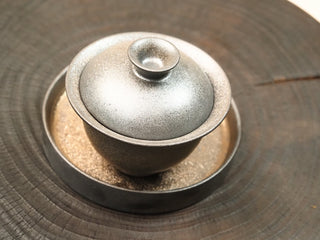 Top view of wood-fired stoneware gaiwan set from Dehua Fujian showing lid, bowl and tea tray, earthy brown kiln-change glaze.