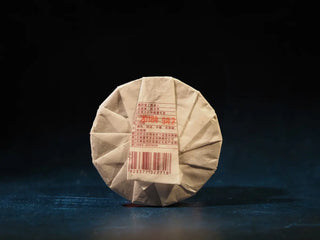 Back view of the Yunnan Red Glow Ripe Pu-erh Tea Mini Cake – 100g packaging with detailed product label and seal, highlighting authenticity.