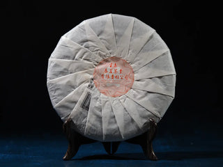 Back view of Spring Ming 2017 Aged Sheng Pu-erh Tea Cake – 400g (Lincang, Yunnan) highlighting packaging details and tea information.