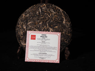 Close-up of the official English description and brewing guide insert card for Orientaleaf's 2023 Iron Fire Lao Man'e Puerh.