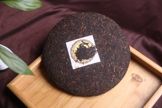 Close-up of dry-stored Lincang ripe puerh tea cake texture, indicating clean and professional aging since 2017.