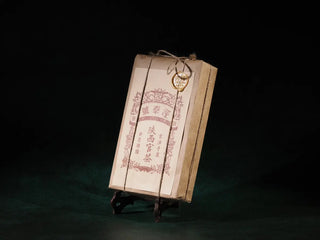 Side view of Jingyang Golden Flower Fu Brick Tea highlighting the thickness and hand-pressed structure of the 1kg dark tea brick.