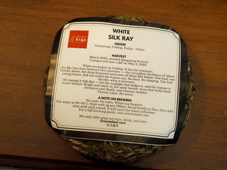 Technical back label description of Silk Ray Fuding Bai Mu Dan white tea cake, displaying harvest date, origin Guanyang, and tasting notes.