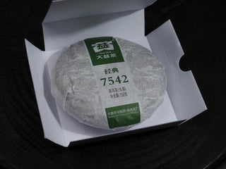 Unboxing the 2020 Dayi 7542 batch 2001 raw puerh tea cake wrapped in cotton paper inside its box.