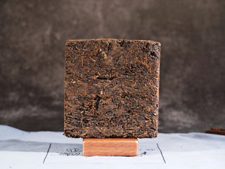 Compressed 2014 Vintage Fuzhuan Heicha dark tea brick texture.