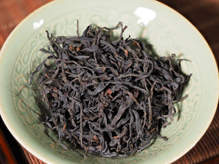 Premium Wild Wilderness Dianhong Black Tea leaves in ceramic bowl