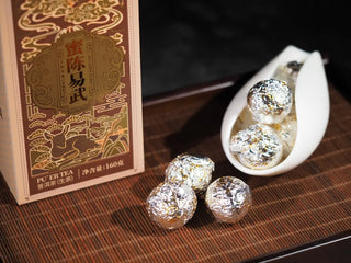 Individual Dragon Pearl Raw Pu-erh tea balls wrapped in silver foil for freshness.