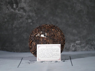Yiwu Raw Pu-erh Cake – 2013 Spring Tea, Hand-Pressed 2023, Sweet & Layered (100g) unwrapped with inner tea card, showing tea texture and product authenticity
