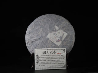 Yunnan Jinggu White Peony Tea Cake 357g with inner product card, removed from packaging, showing premium handcrafted quality