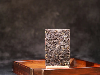 Solid pressed 2023 Yunnan Fengqing Fu Brick Tea showing authentic leaf texture.