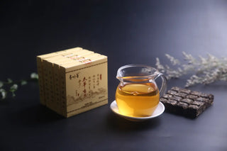 Taihua Ancient Tree Raw Pu-erh 2016 Waffle Biscuit with Golden Tea Liquor in a Cup, Highlighting Portable Brewing.