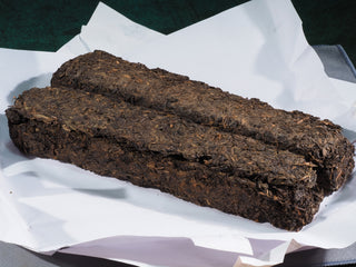 Close-up of the dry 2015 Fu Brick Hei Cha, showing the tightly compressed and naturally aged dark tea texture.
