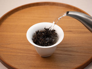 Hot water being poured over Yunnan Golden Empress Oolong tea leaves