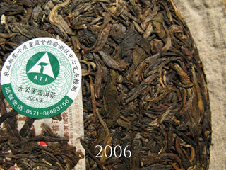 Original inner ticket (Neifei) embedded in the 2006 Arbor King Puerh cake for authenticity.