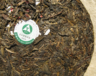 Close-up of the internal Neifei trademark embedded in the 2005 Mengku raw Pu-erh cake.