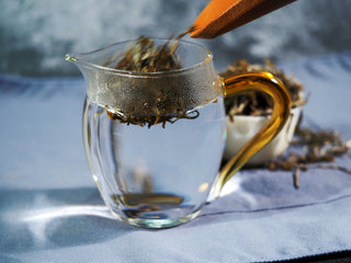 Steeping Ailao Golden Bud Yellow Tea in a glass pitcher to show the tea leaves dancing.