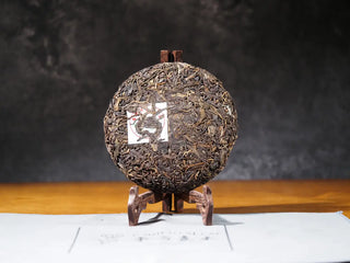 Front unwrapped view of the Sticky Rice Aroma Raw Pu-erh Cake 2013 200g showing cake texture