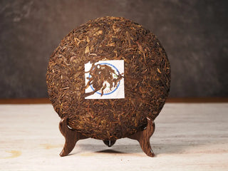 Front unwrapped view of Value Classic 2008 Tribute Sheng Pu-erh Tea Cake – 357g Menghai (2019 Pressed), revealing tea leaf texture