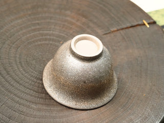 Bottom of wood-fired stoneware gaiwan bowl from Dehua Fujian, unglazed foot ring showing the raw clay body of the kiln-fired stoneware.