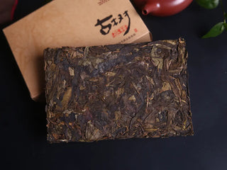 High-resolution close-up of the broken Xiangzhuqing brick, highlighting the signature golden leaf buds.